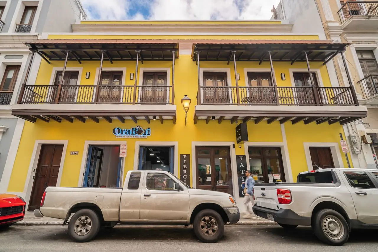 Building's yellow facade with iron balconies — Royal Palm Old San Juan