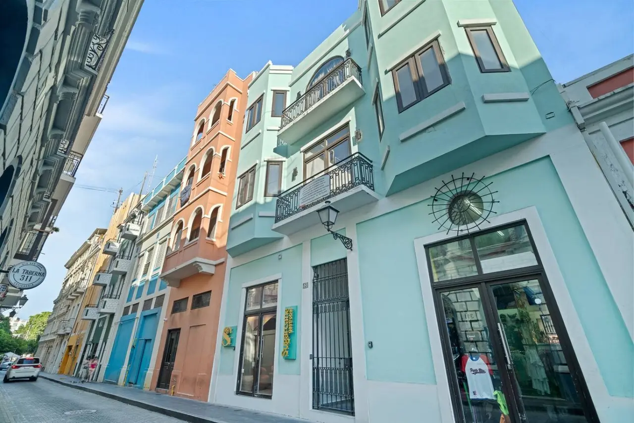 Building's mint-green facade with iron balconies — The Galleria House | Private Patio Old San Juan
