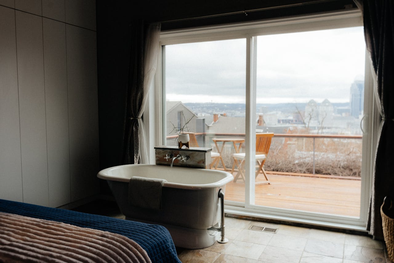 Elegant bathroom featuring a freestanding tub and balcony view, perfect for a relaxing retreat.